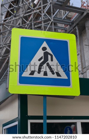 Russia, Moscow. 06.30.2018. Photo of blue pedestrian crossing sign with yellow retro-reflective band.
