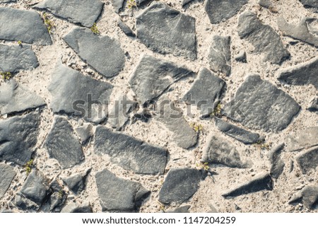 Old road made of cobblestone. Top view