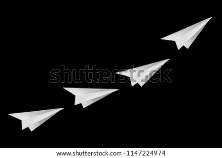Paper planes isolated on black background.