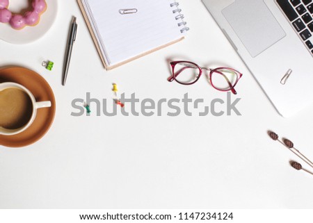 Flat lay workspace picture, cup of coffee, donut , notebook and pen on white background. Business workplace concept. Work desktop with coffee, enjoy working.