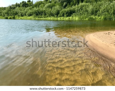 Shallow water on the bank of a large river.