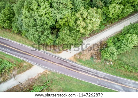 Aerial view of Katy Trail crossing highway near Pilot Grove, Missouri> it is a 237 mile bike trail stretching across most of the state of Missouri converted from abandoned railroad. Royalty-Free Stock Photo #1147262879