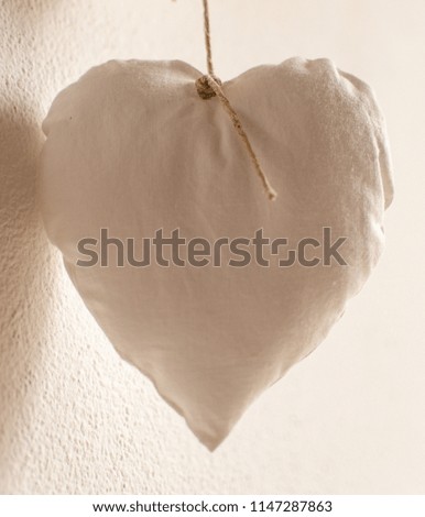 White heart pillow on a string