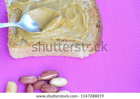 Peanut butter sandwiches or toasts on purple background