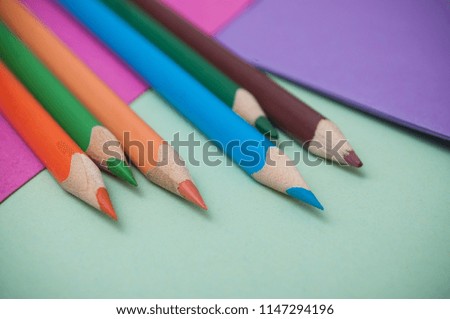 closeup of colouring pencils on color background
