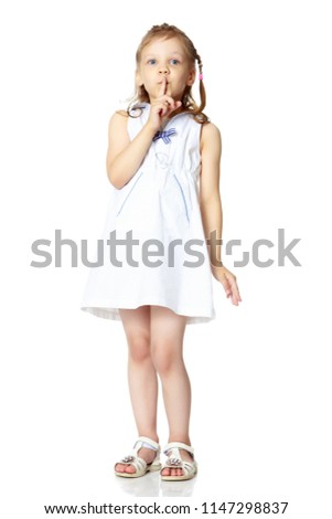 Little girl, the gesture is quiet. The concept of secrecy, games, observance of silence. Isolated over white background