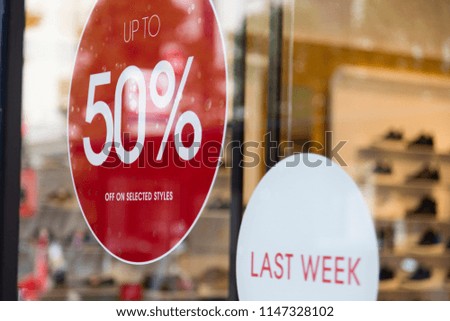 Sale sign in a retail shop window. shopping discount