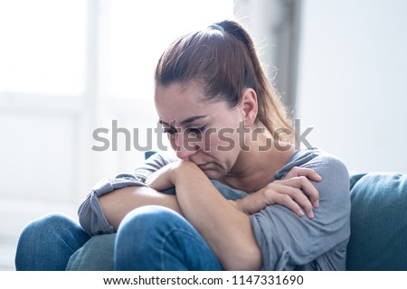 Young attractive latin woman lying at home living room couch feeling sad tired and worried suffering depression in mental health, problems and broken heart concept. Royalty-Free Stock Photo #1147331690