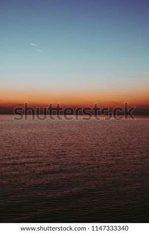 Silky smooth water with sunset in the background
