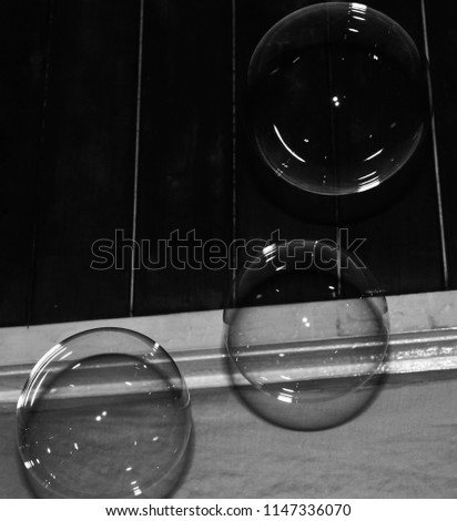 A black & white, digitally altered photograph of a group of floating bubbles. This photo was taken in Brisbane, Australia. 