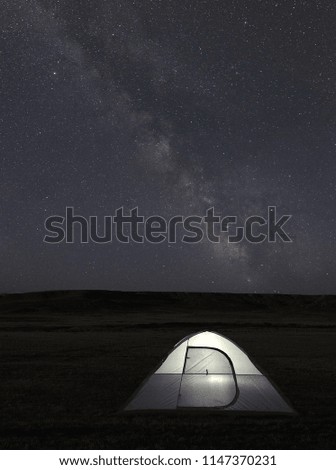 Milky Way Stars Over Illuminated Tent at Night         
