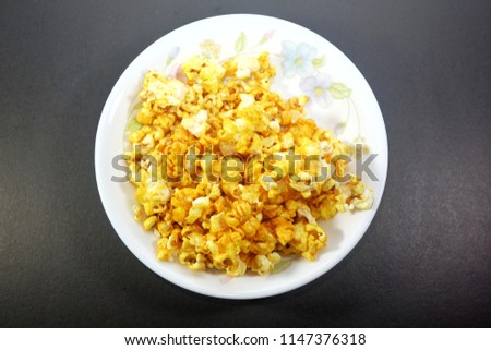 A top down picture of pop corn eat while watching movie. A single 3-cup serving provides 80 calories, 15 g of carbohydrates, about 1 g of protein and less than 1 g of fat.