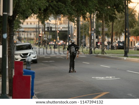 unknown man is skateboarding to work