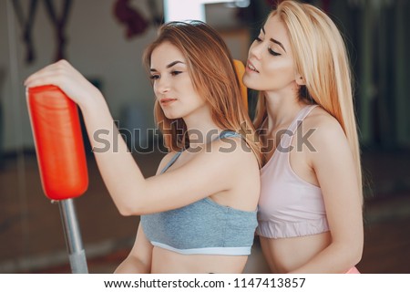 two beautiful girls engaged in sports gymnastics and sports in the gym