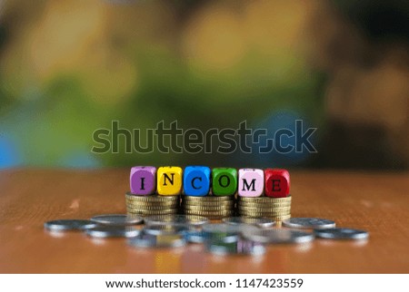 Stack coins and dice alphabet with text income