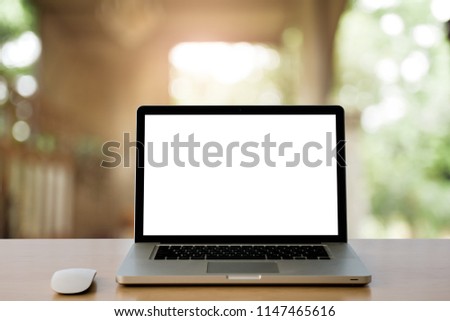 Conceptual workspace,Empty space Wooden Desk with on Laptop screen and wireless mouse,at home blurred background at light bokeh.