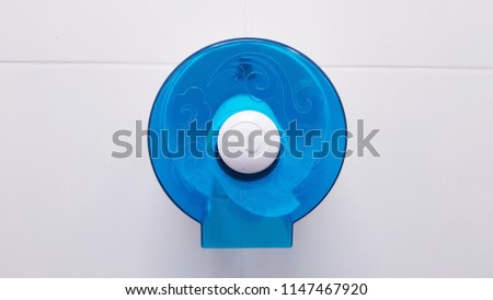 Transparent blue box for wall mounting ,.blue Paper towel dispenser on the wall in the bathroom