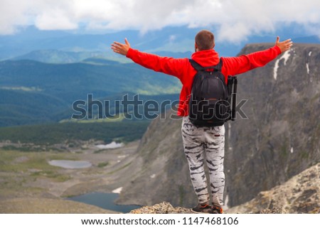 Man hiker enjoy the view at sunset mountain peak cliff.Photographer traveler on  high mountaint  Stylish man hiking. Travel Lifestyle and survival concept rear view