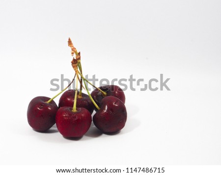 cherries are lying on white background