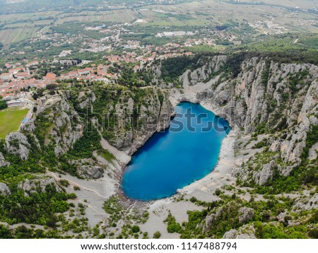 Blue Lake (Croatian: Modro jezero or Plavo jezero) is a karst lake located near Imotski in Croatia. It lies in a deep sinkhole possibly formed by the collapse of an enormous cave. Royalty-Free Stock Photo #1147488794