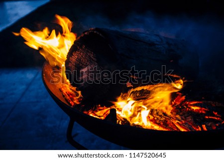 Night scene of fire sparks and flame burning with beautiful red flame.