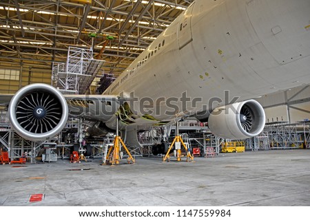 Aircraft (airplane) lift up from the floor by aircraft jack for maintenance at aircraft hangar.Aircraft on jack in hangar for maintenance service check by mechanic. Royalty-Free Stock Photo #1147559984