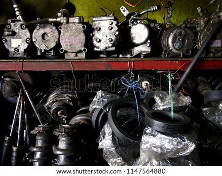 Photo of assorted used car or automobile spare parts on display at a surplus shop