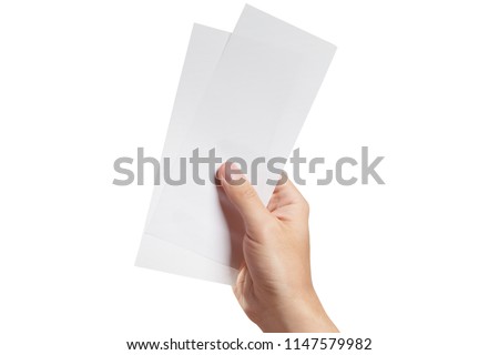 Male hand holding two blank sheets of paper (tickets, flyers, invitations, coupons, banknotes, etc.), isolated on white background Royalty-Free Stock Photo #1147579982