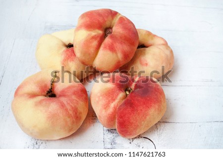 Fig peaches on a white wooden background.Macro picture.
