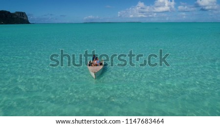 A couple in a boat in aerial view, French Polynesia