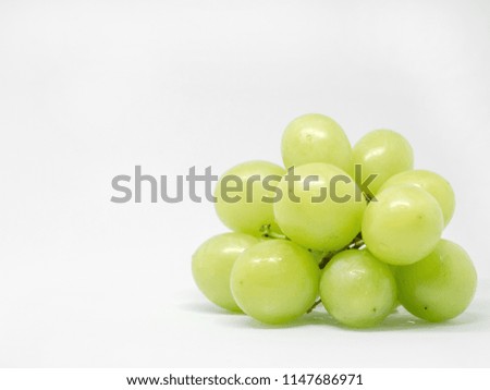 A bunch of green grape fruits on a white background. Organic fruits from Thailand.