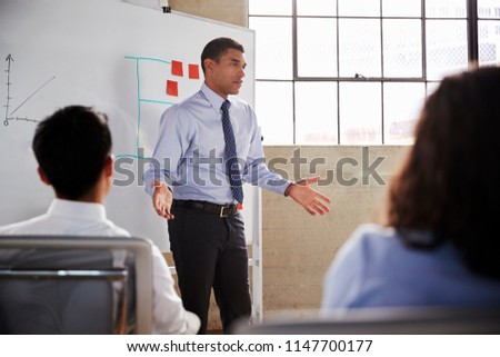 Businessman gesturing during a presentation, close up