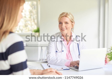 Shot of female doctor talking to woman and discussing about medical report at the doctor's room. 