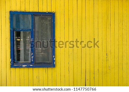 Old window on a yellow background