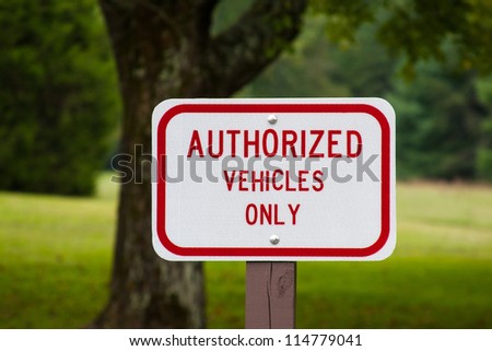 Authorized vehicles only warning sign on a post
