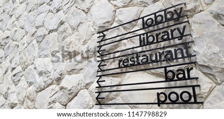 Steel hotel sign on a rock background