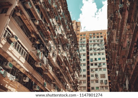 Hong Kong urban architecture background, huge block of flats walls. Vintage stylized photo with tonal correction filter