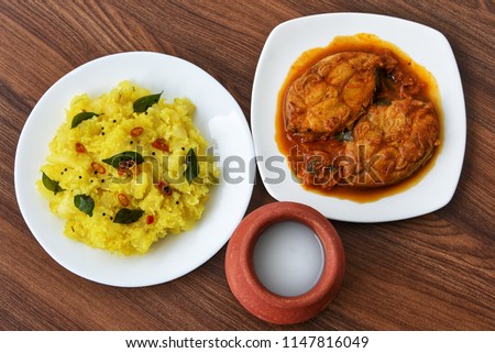 Cooked tapioca or Cassava root , Mandioca or Aipim with  spicy Fish curry, palm wine or toddy, Kerala, India. Prepared with grated coconut South Indian food, Kappa Puzhukku. vegetable Brazil.