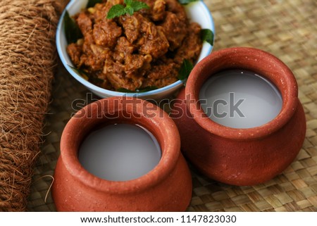 Palm Wine or Coconut Toddy popular Drink in Kerala India. It is a alcohol produced from coco tree and very commonly used in Tuvalu. Good combination with spicy hot fish or meat curry Royalty-Free Stock Photo #1147823030