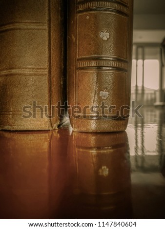Old book with leather binding, vintage and retro background with ancient books, detail and closeup of old book