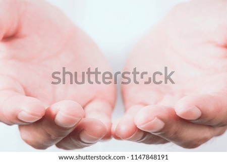 close up of male hands as if holding something. intended focused finger tips.