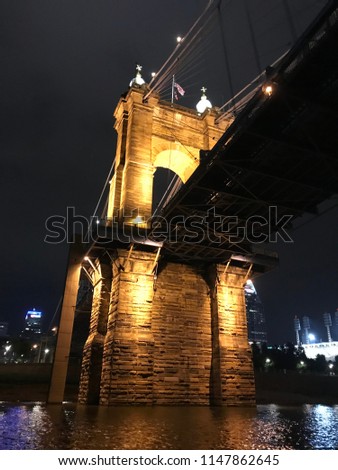 John A. Roebling suspension bridge on the Ohio river. Between Covington, KY and Cincinnati, OH. Cincinnati Skyline and Reds stadium in the background.
