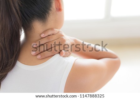 Closeup woman neck and shoulder pain and injury. Health care and medical concept. Royalty-Free Stock Photo #1147888325