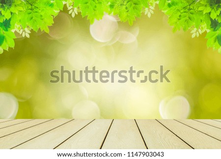 Brown wood table,morning sunshine,concept relaxation and natural healing,light green leaves and sunlight,blurred backgrounds,beautiful nature bokeh in park and show products or print as cards.
 