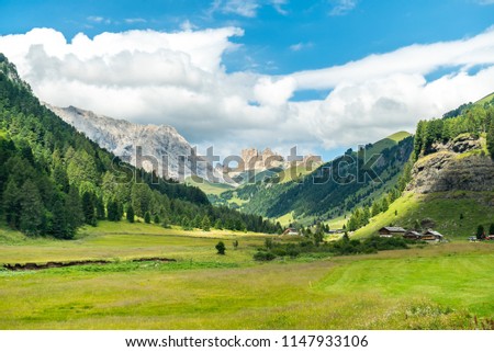 Panoramic view of famous Dolomites mountain peaks glowing in beautiful golden evening light in summer, South Tyrol, Italy. Dolomites Landscape. View from the top. Aerial