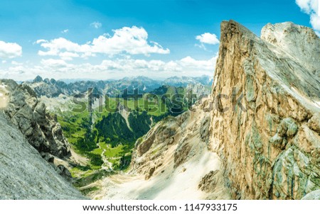 Panoramic view of famous Dolomites mountain peaks glowing in beautiful golden evening light in summer, South Tyrol, Italy. Dolomites Landscape. View from the top. Aerial