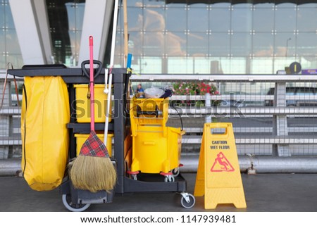 Closeup of cleaning equipments and tools for floor cleaning at the airport with outside terminal background. Royalty-Free Stock Photo #1147939481