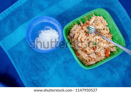 Pasta salad picnic on towel. Nice landscape of food vacation. Travel picture series.