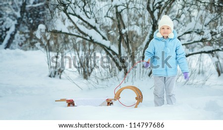 Little girl on sledge