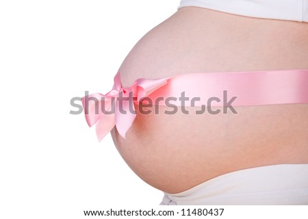 It is a girl. Isolated 29-weeks pregnant belly with pink bow over it
